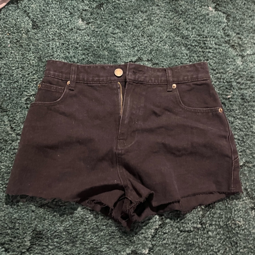 Black denim shorts with white shorts on the butt